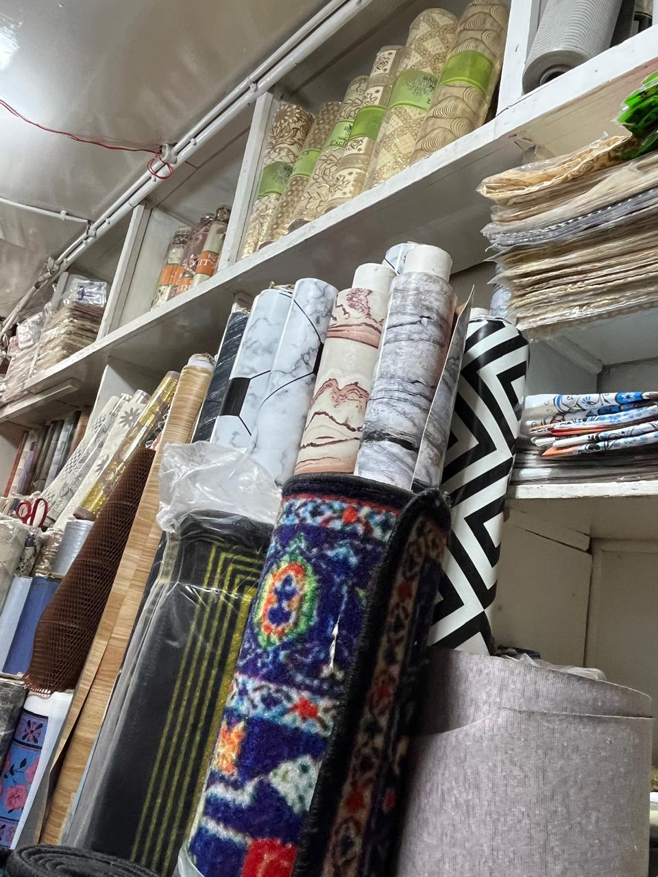 Flooring, carpet and wallpaper rolls in the shop